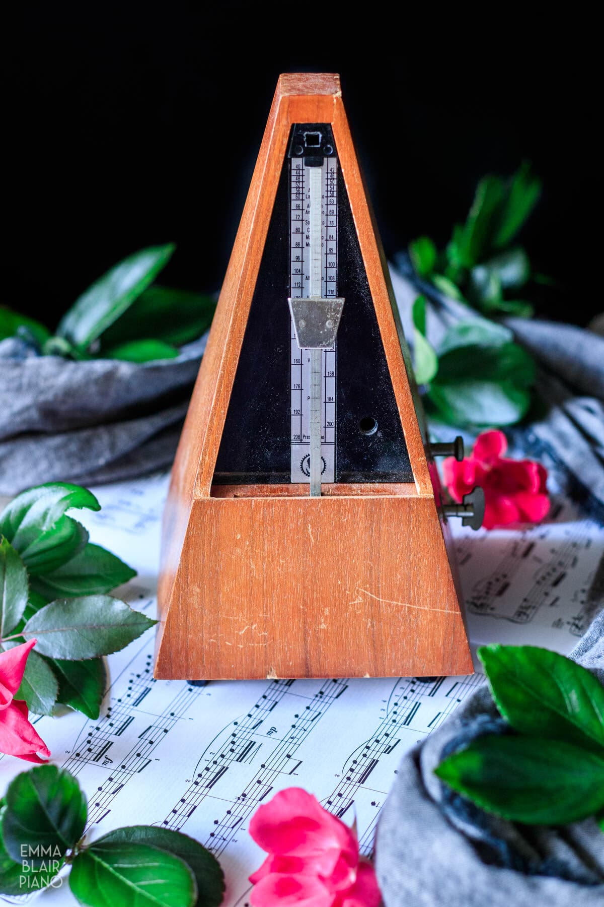 metronome and sheet music with roses