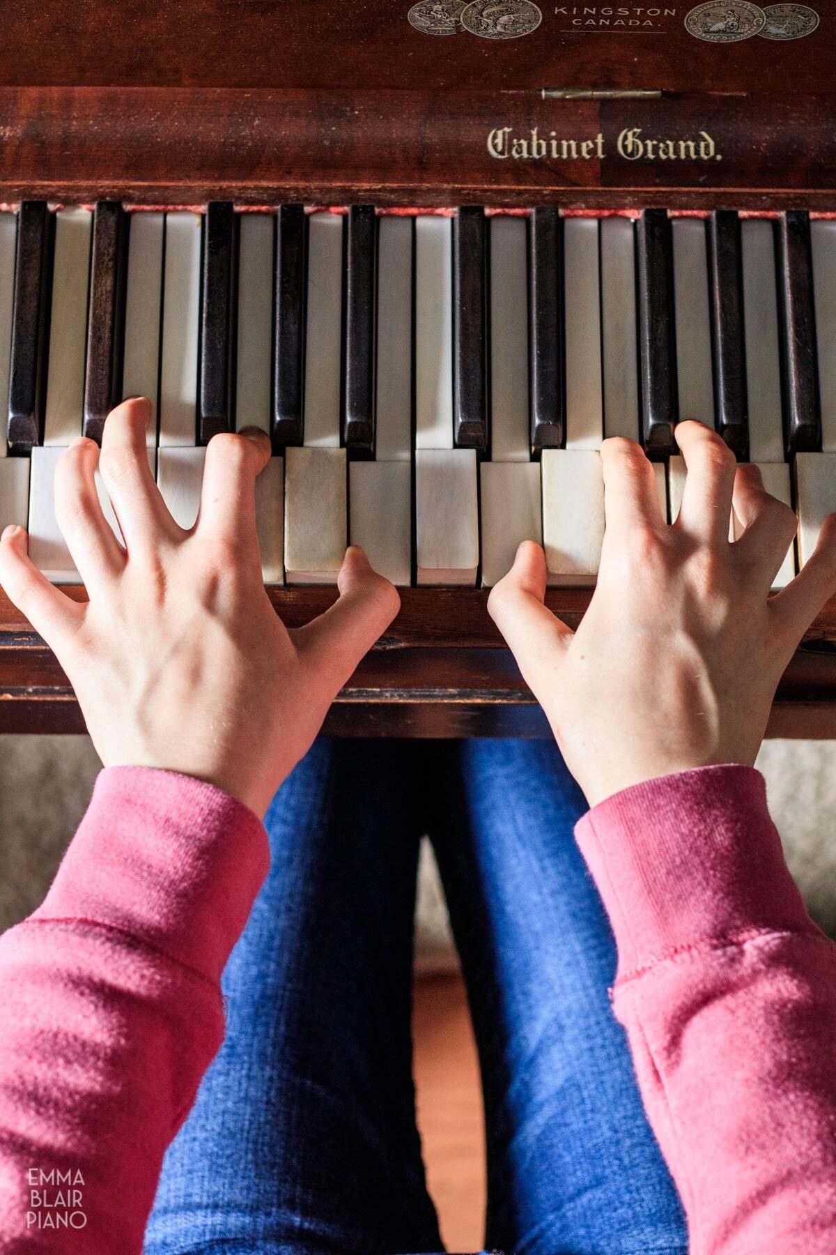 overhead view of a girl playing the piano