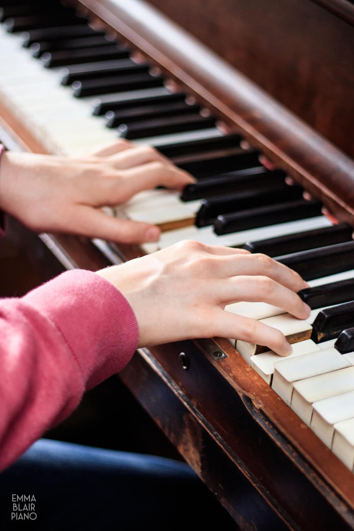 side view of a girl playing the piano