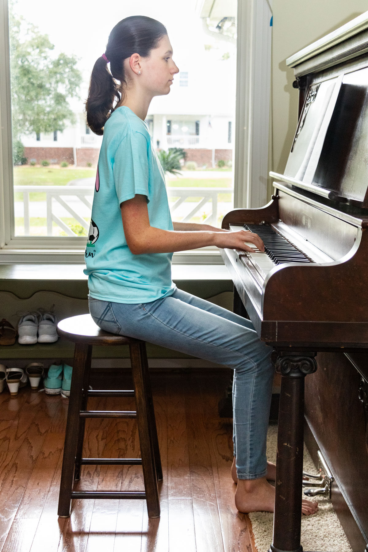 teenage girl sitting at the piano