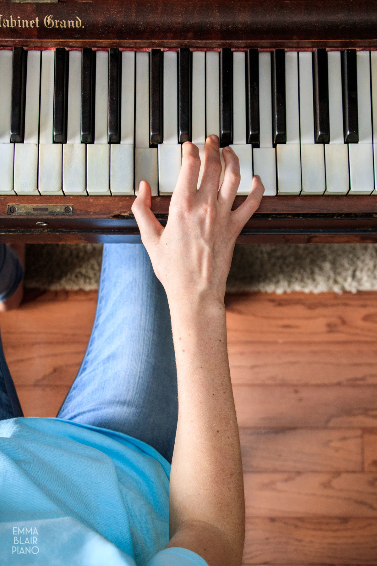 girl demonstrating correct arm and body position at the piano