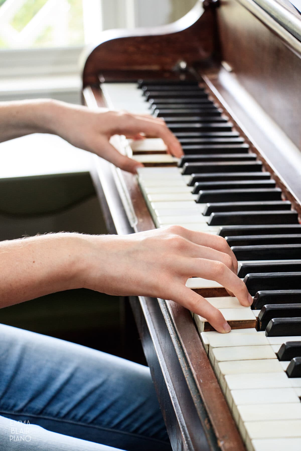 girl demonstrating correct hand and wrist alignment at the piano