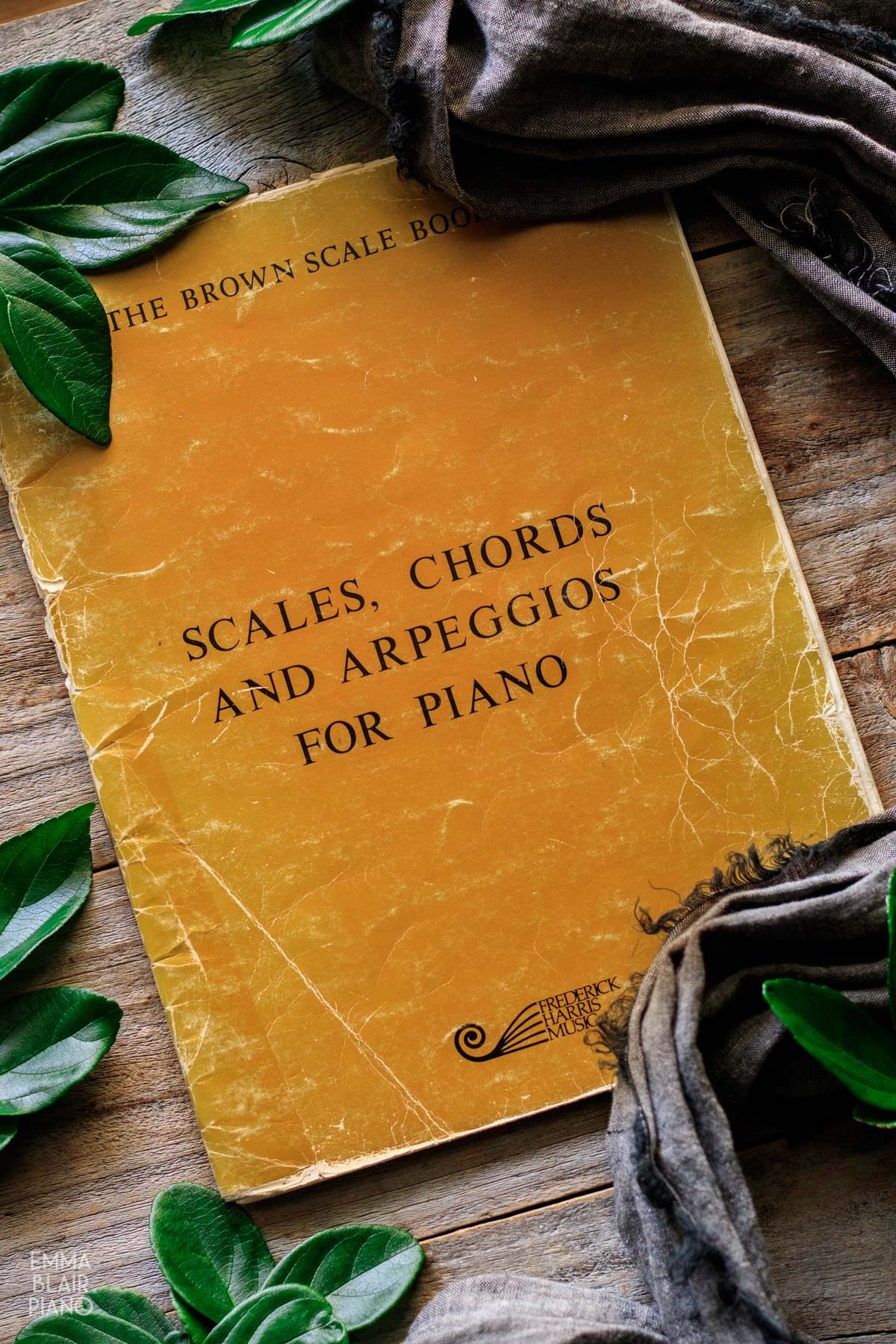 brown book of scales with gray linen and leaves