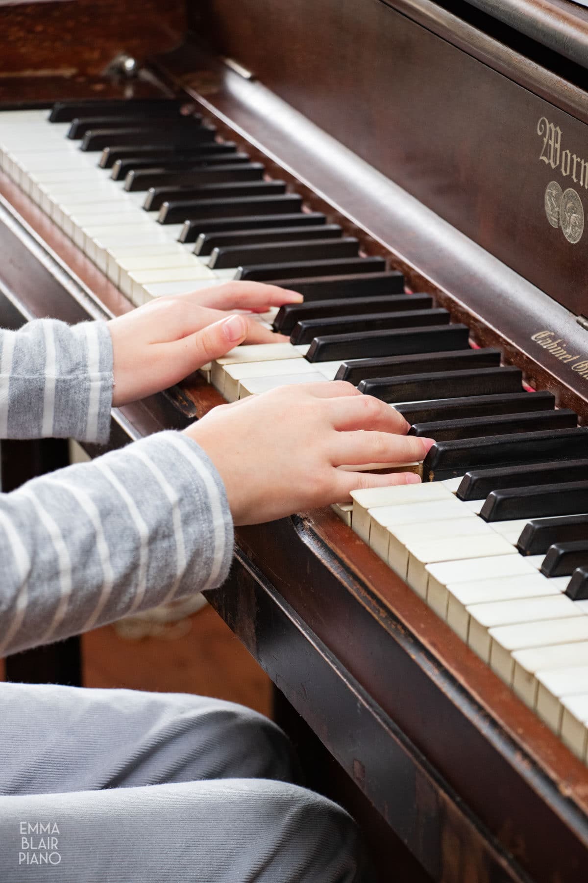 closeup of a young girl's hands playing the piano