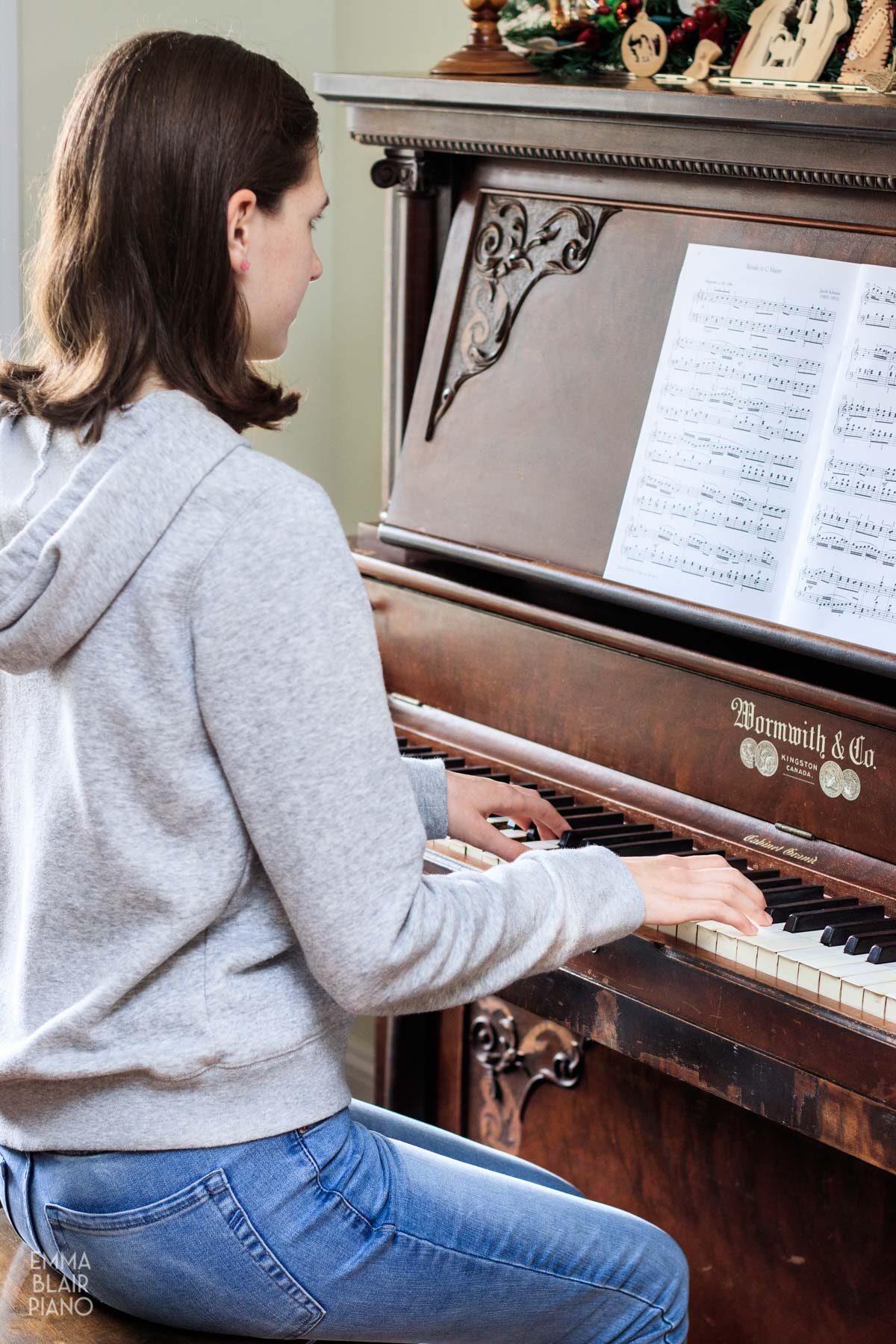 teenage girl practicing the piano