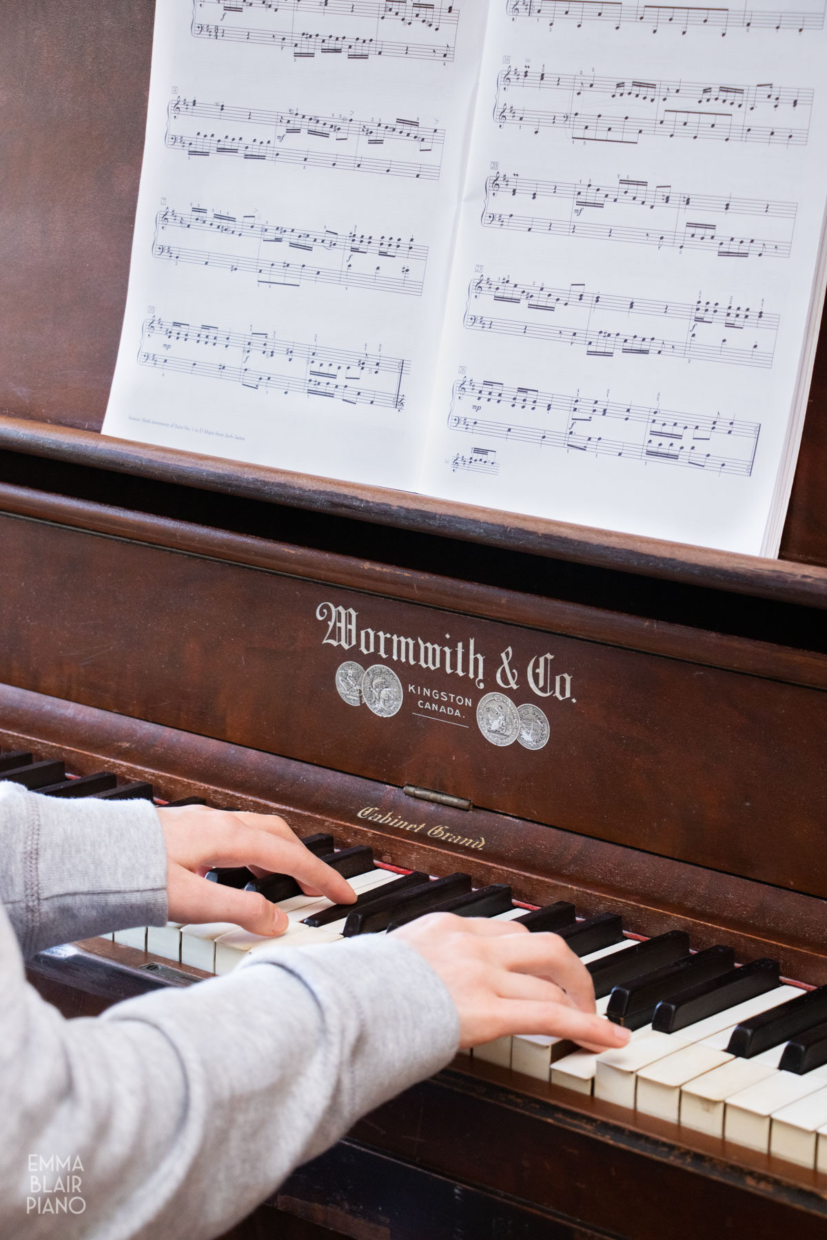 teenage girl playing a song on the piano