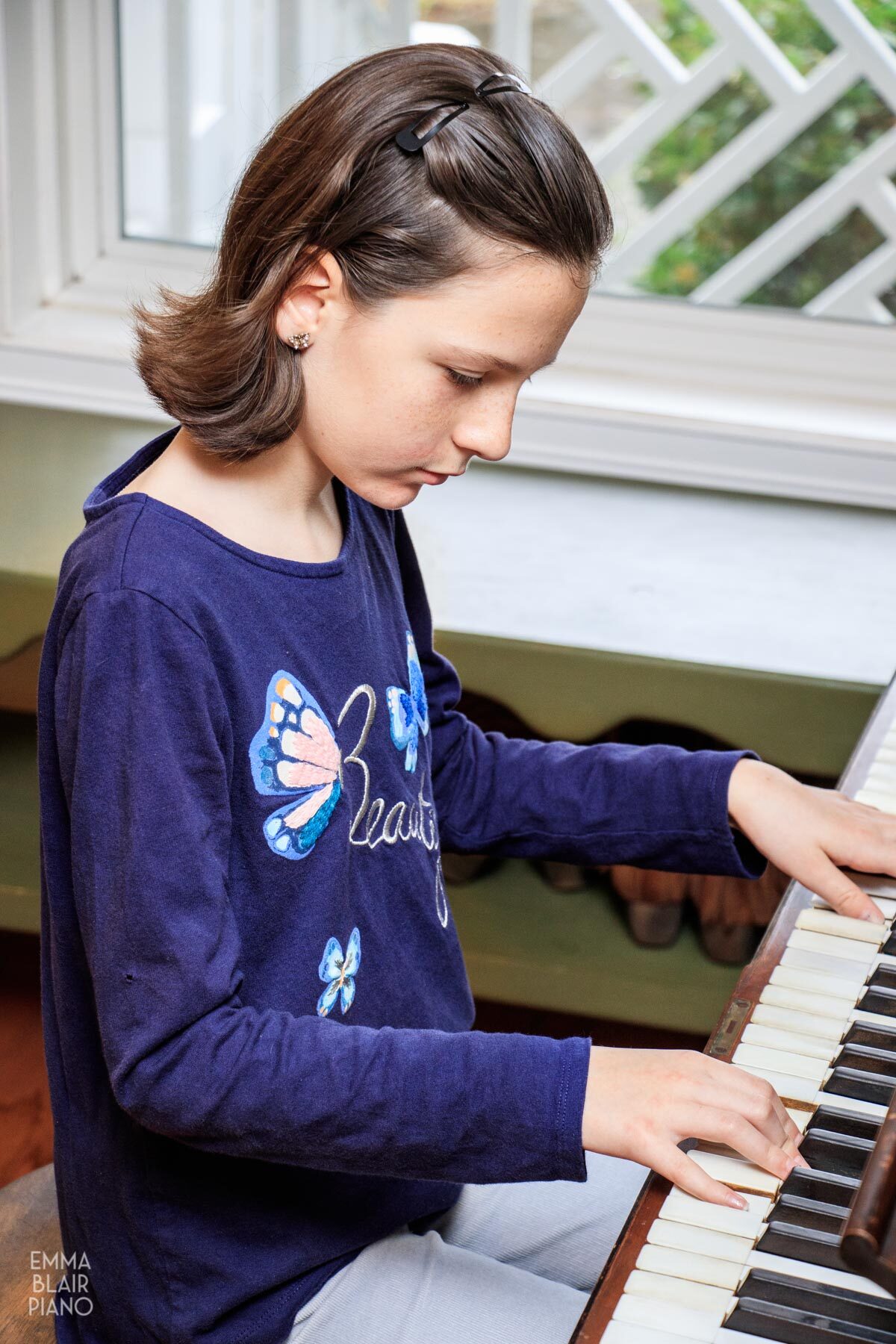 young girl playing the piano