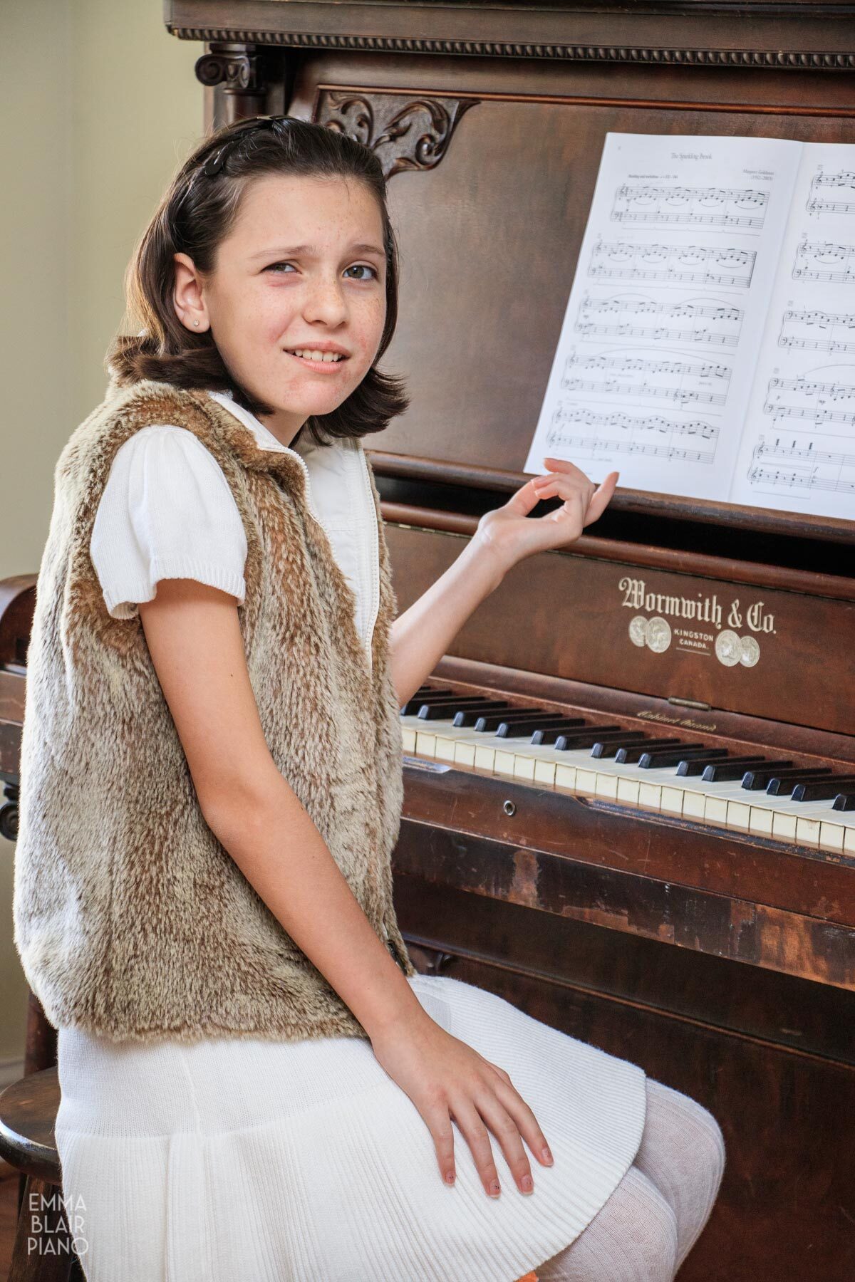 puzzled young girl sitting at the piano