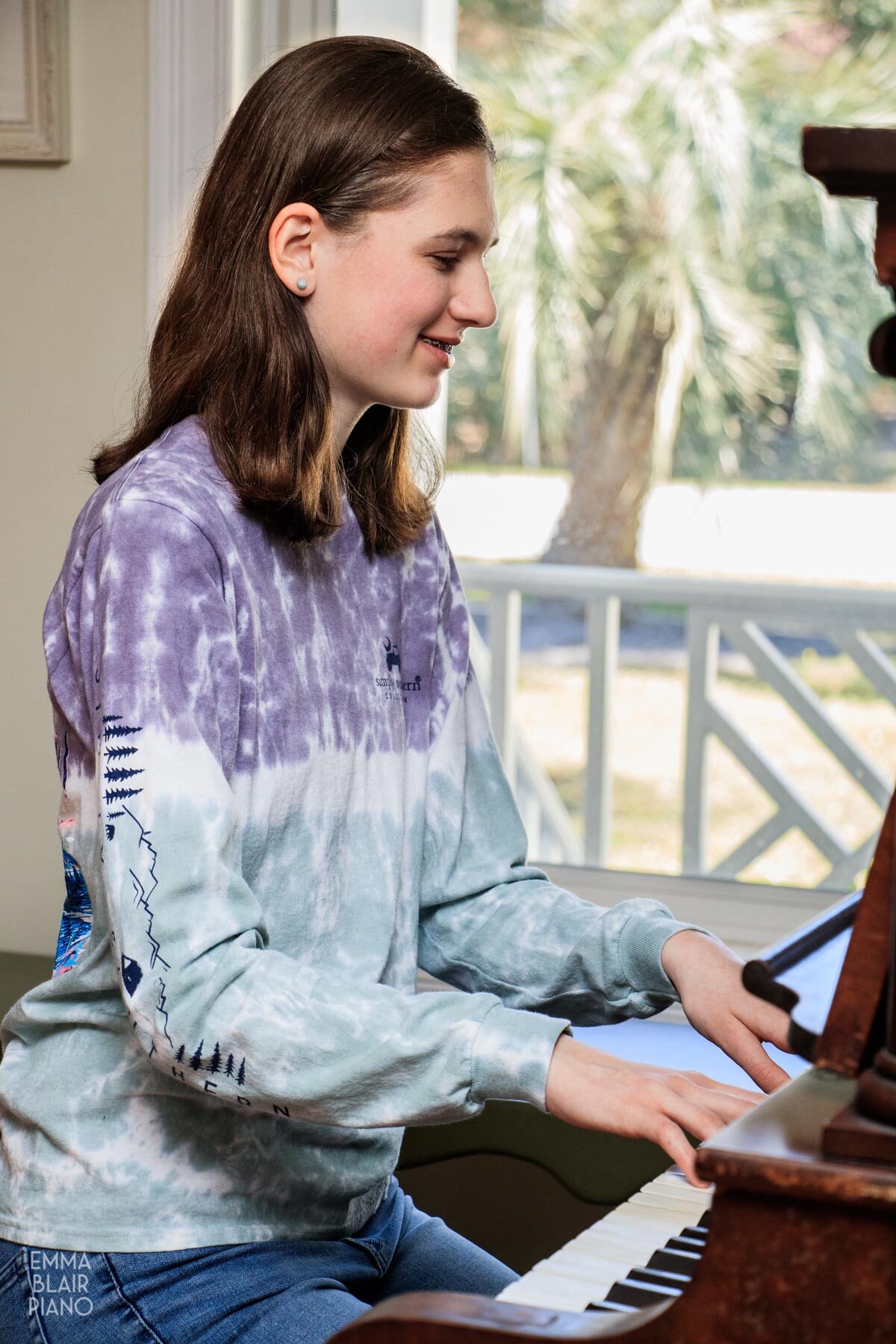 teenage girl playing the piano