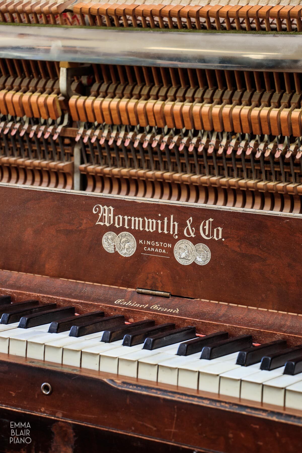 a side view of an upright grand piano action and keyboard