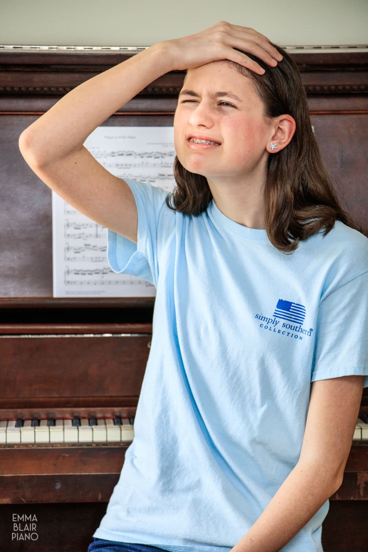 teenage girl feeling nervous about playing the piano