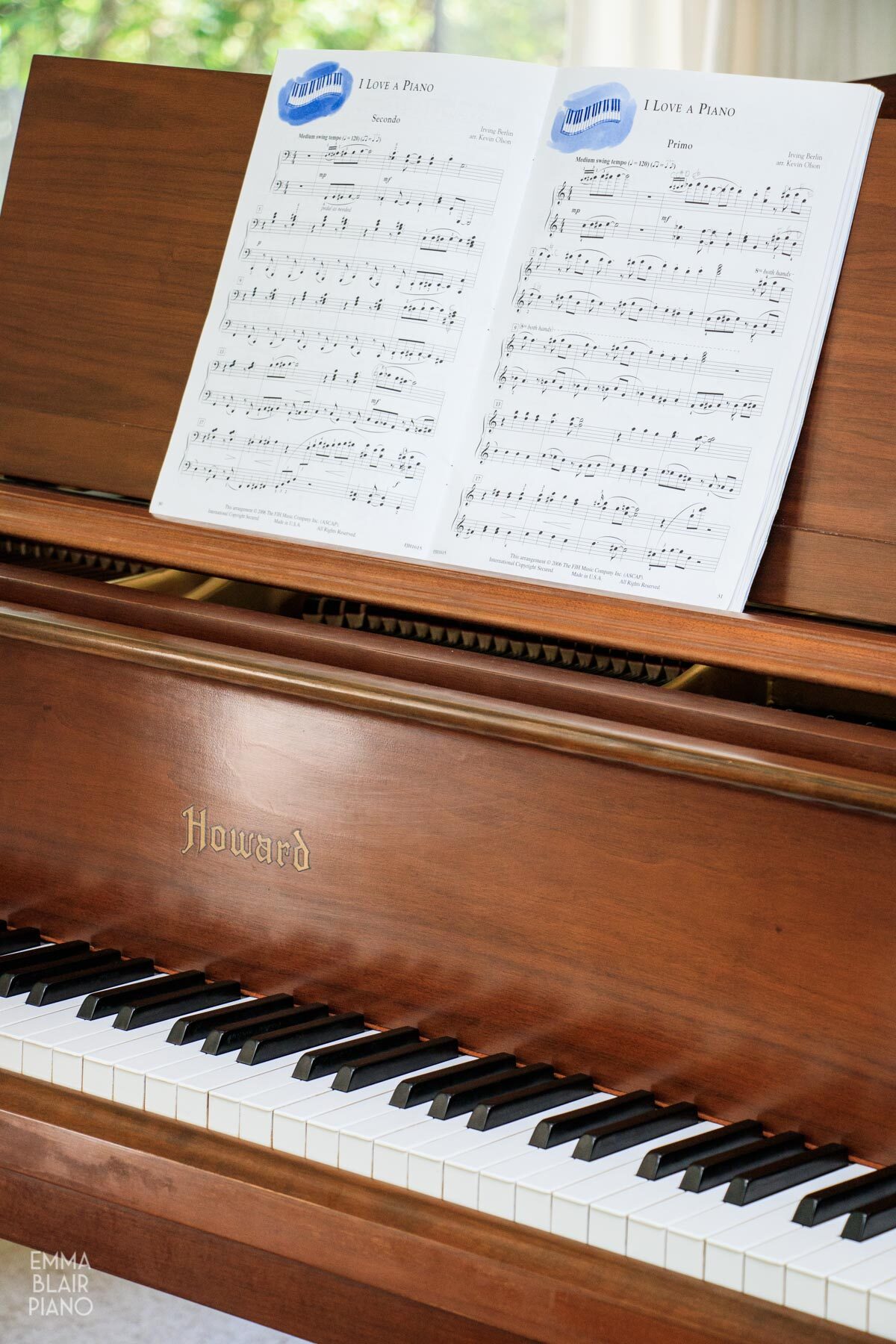 a book of duet piano music on the piano's music stand