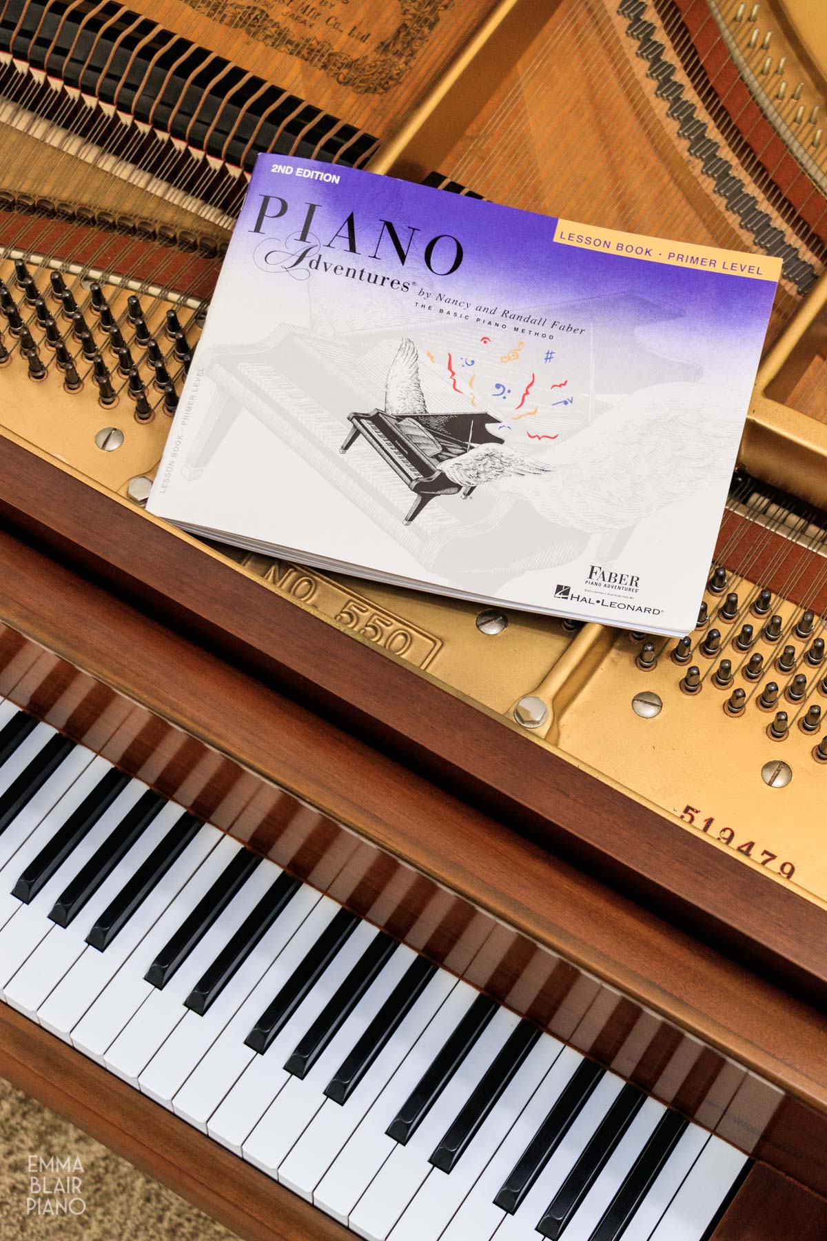 Faber Piano Adventures Primer book on a grand piano