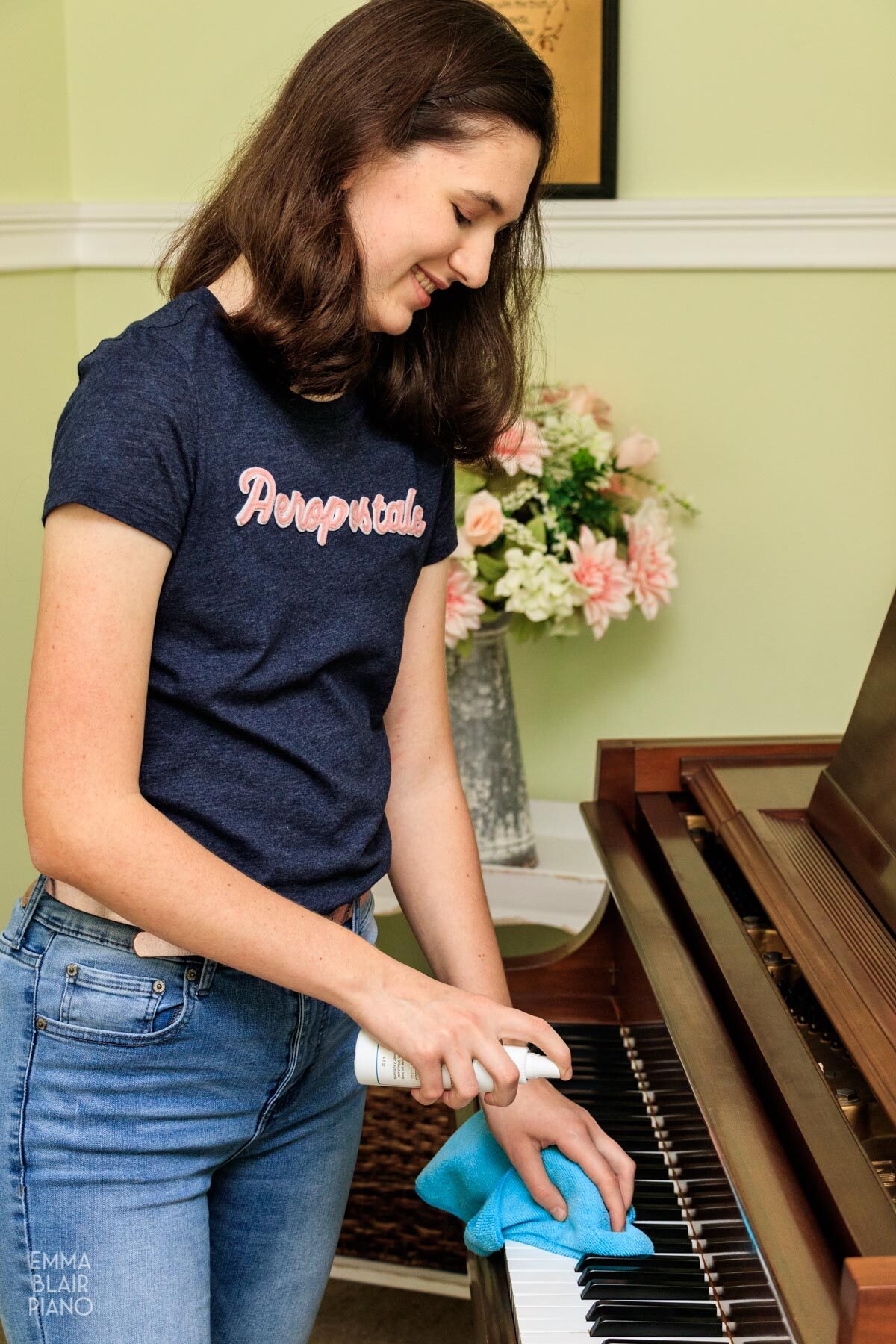 girl cleaning piano keys with Cory Key-Brite spray