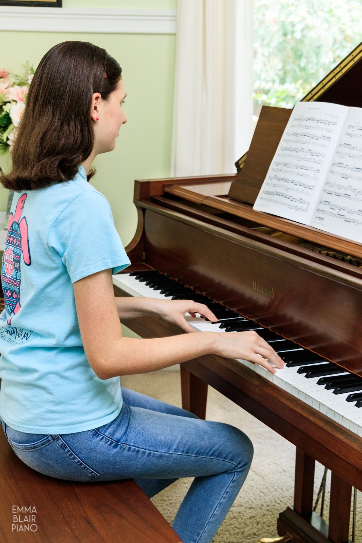 girl playing a classical piano piece with the sheet music