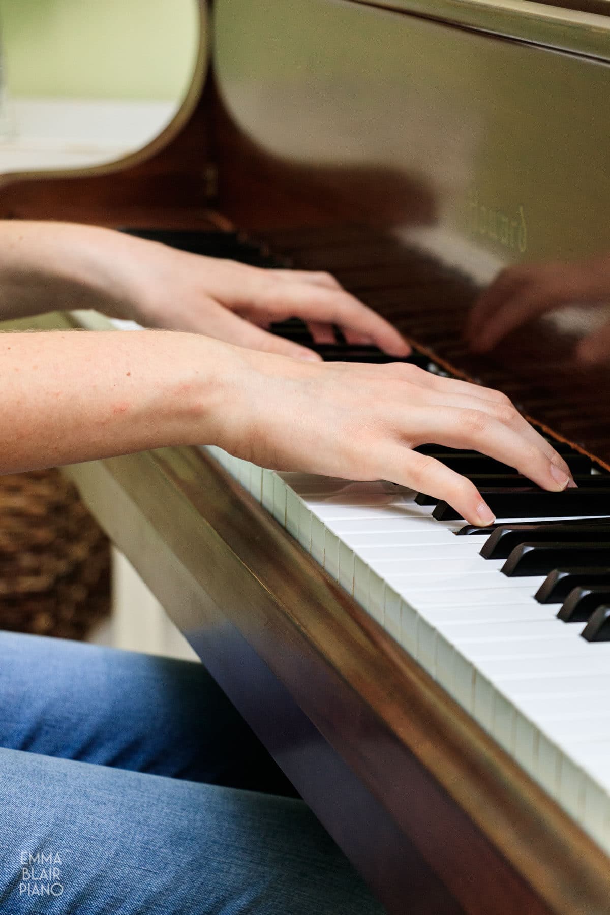 closeup of a teenage girl's hands as she plays the piano