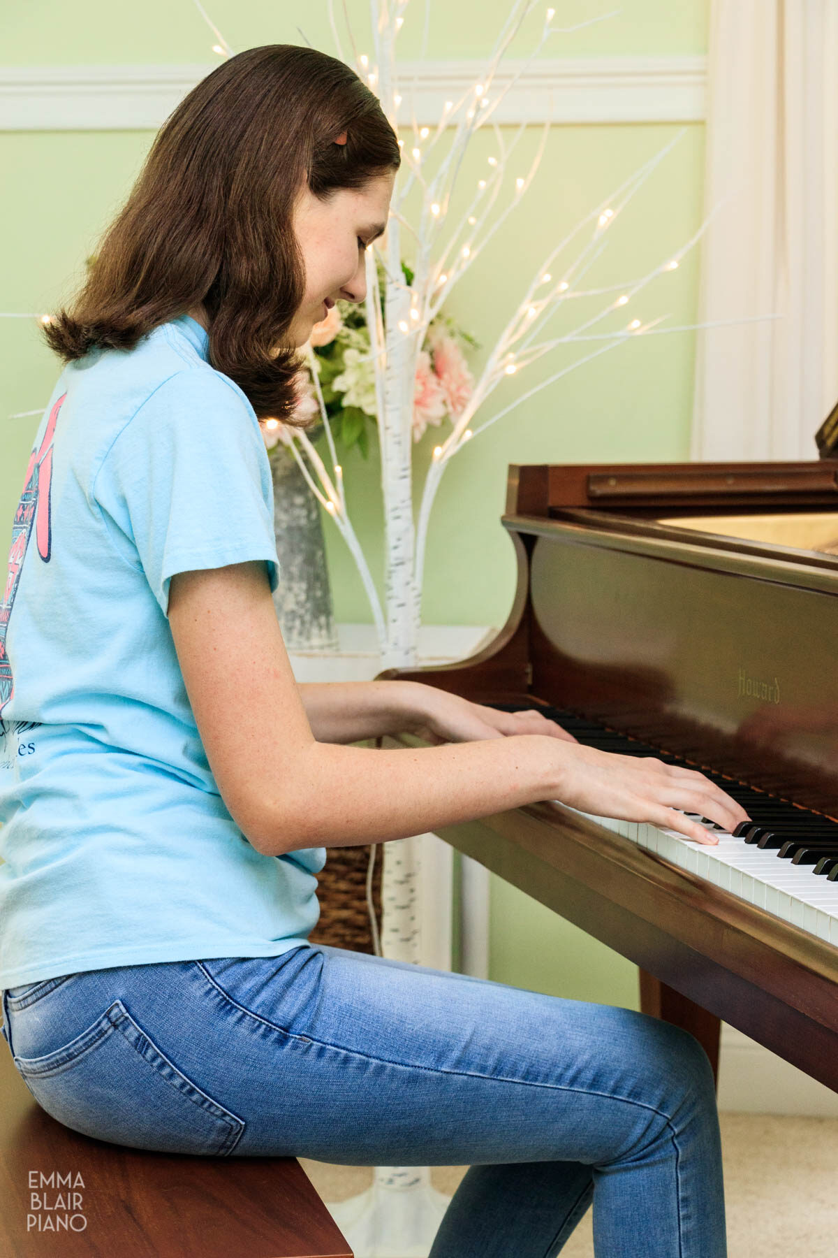 teenage girl playing a piano piece from memory