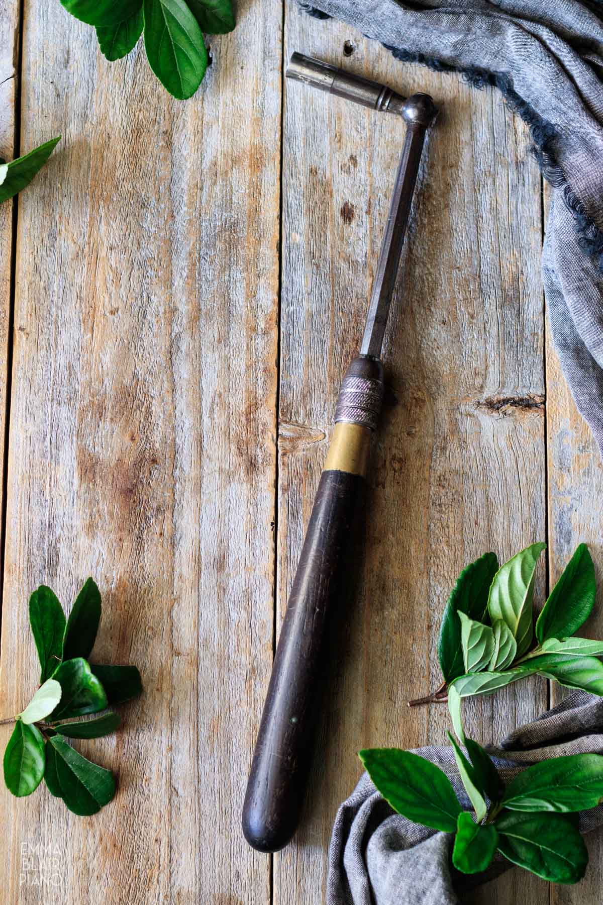 piano tuning hammer laying on gray wooden boards