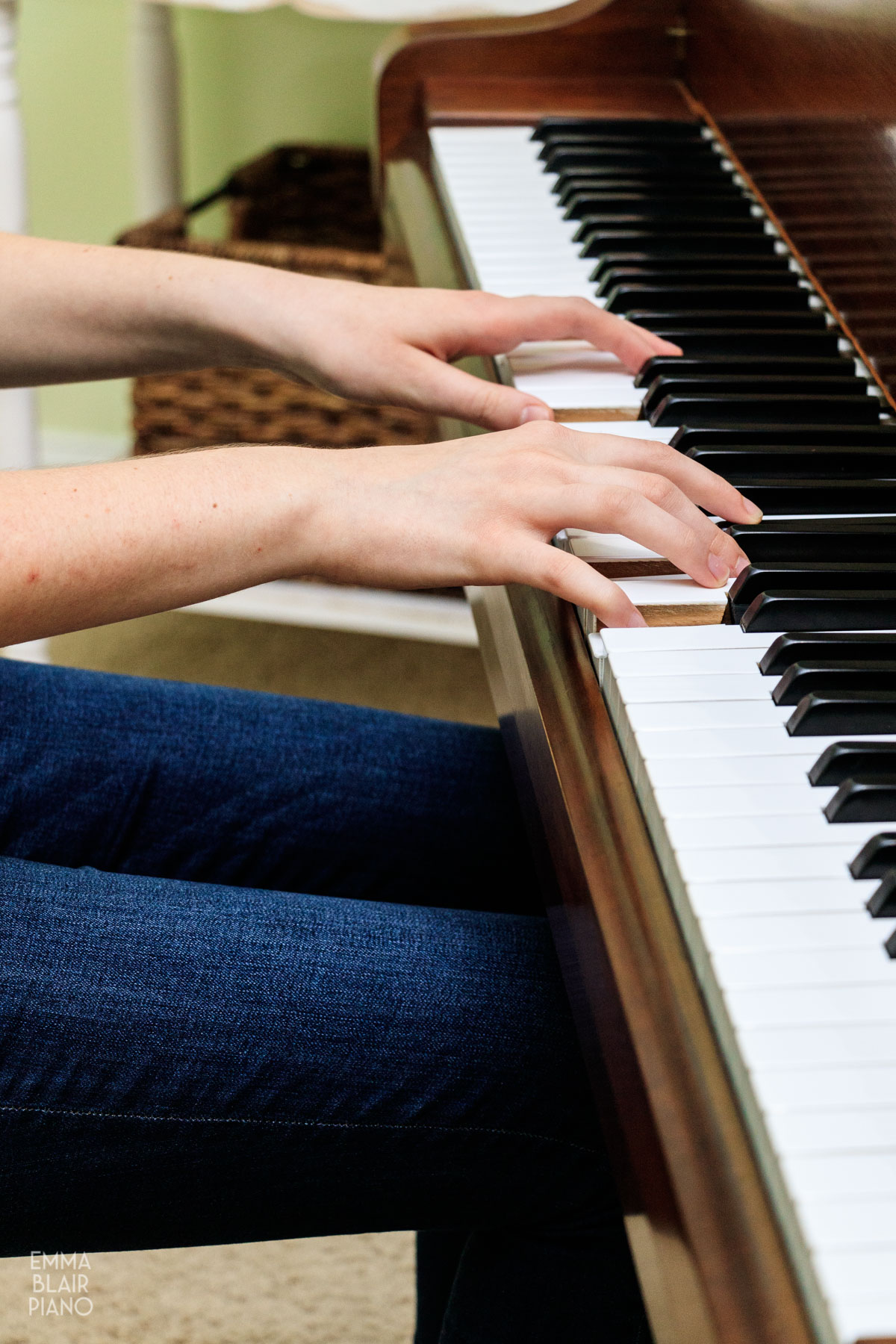 closeup of a girl's hands playing the piano