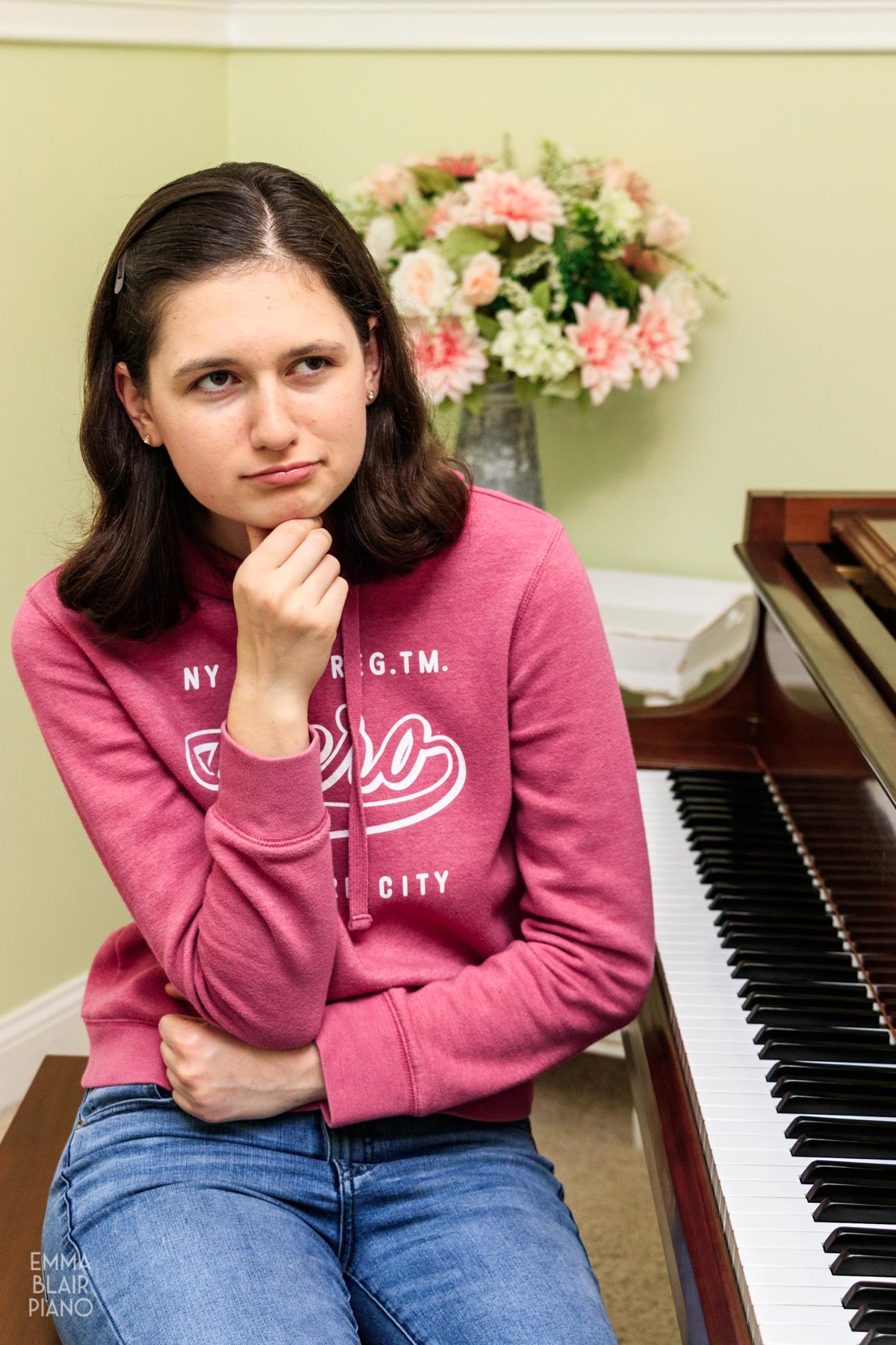 teenage girl thinking at the piano keyboard