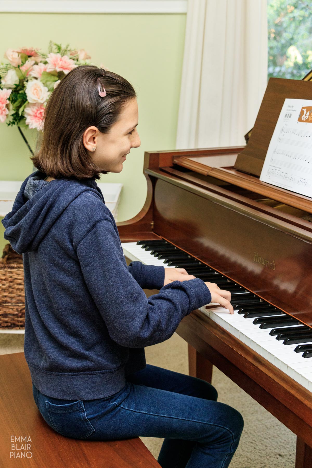 young girl playing a beginner piano piece