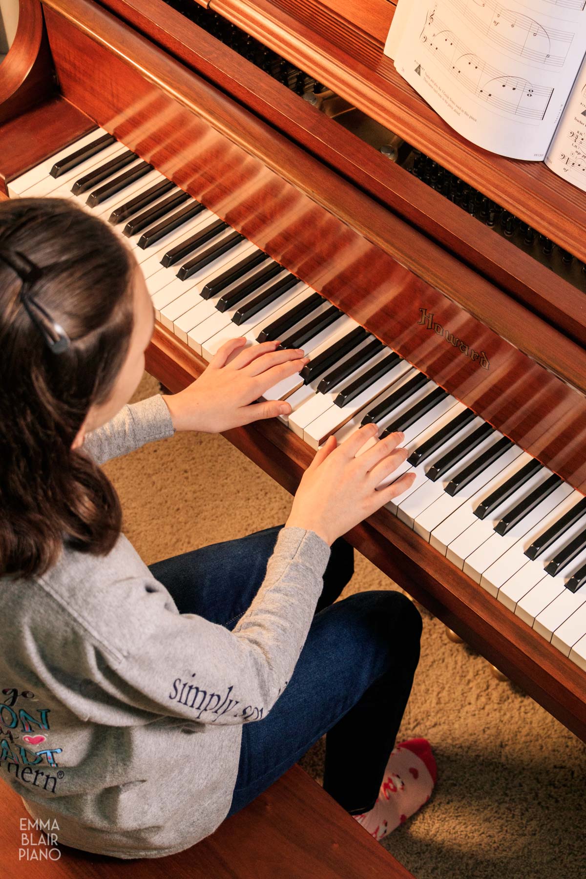 overhead view of a girl playing the piano