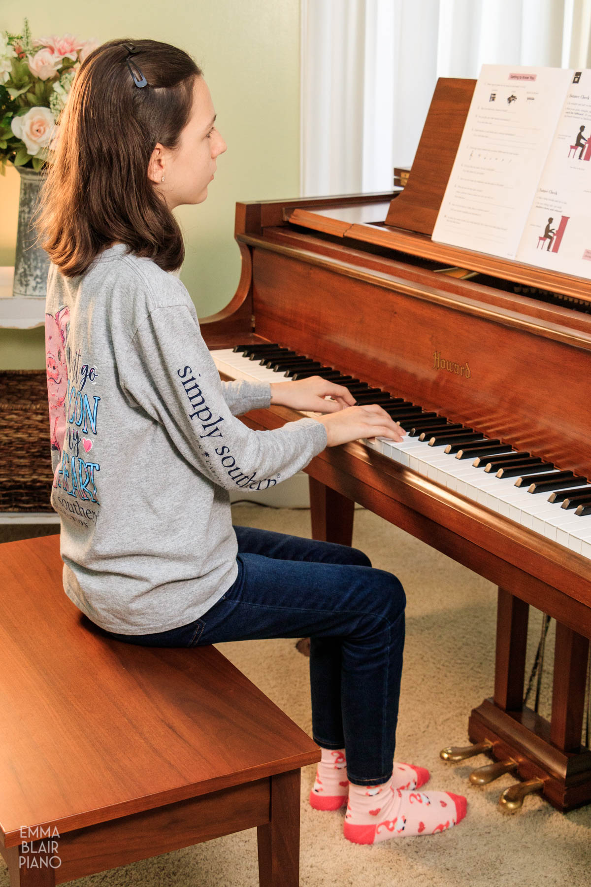 girl sitting with correct posture on the piano bench