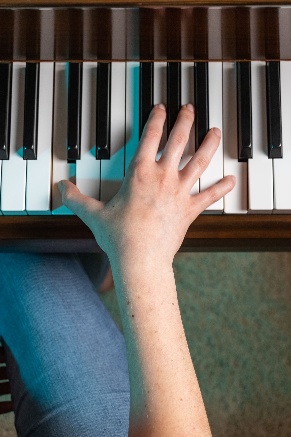 demonstrating a right hand octave on a piano