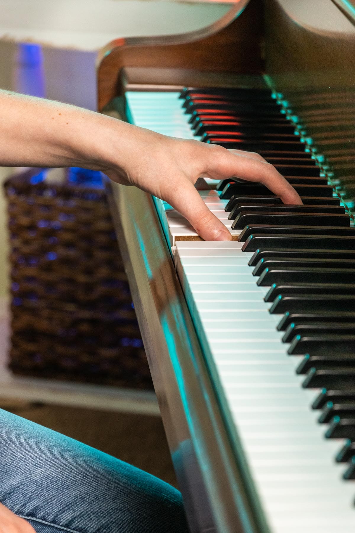 girl demonstrating a left hand octave on a piano keyboard