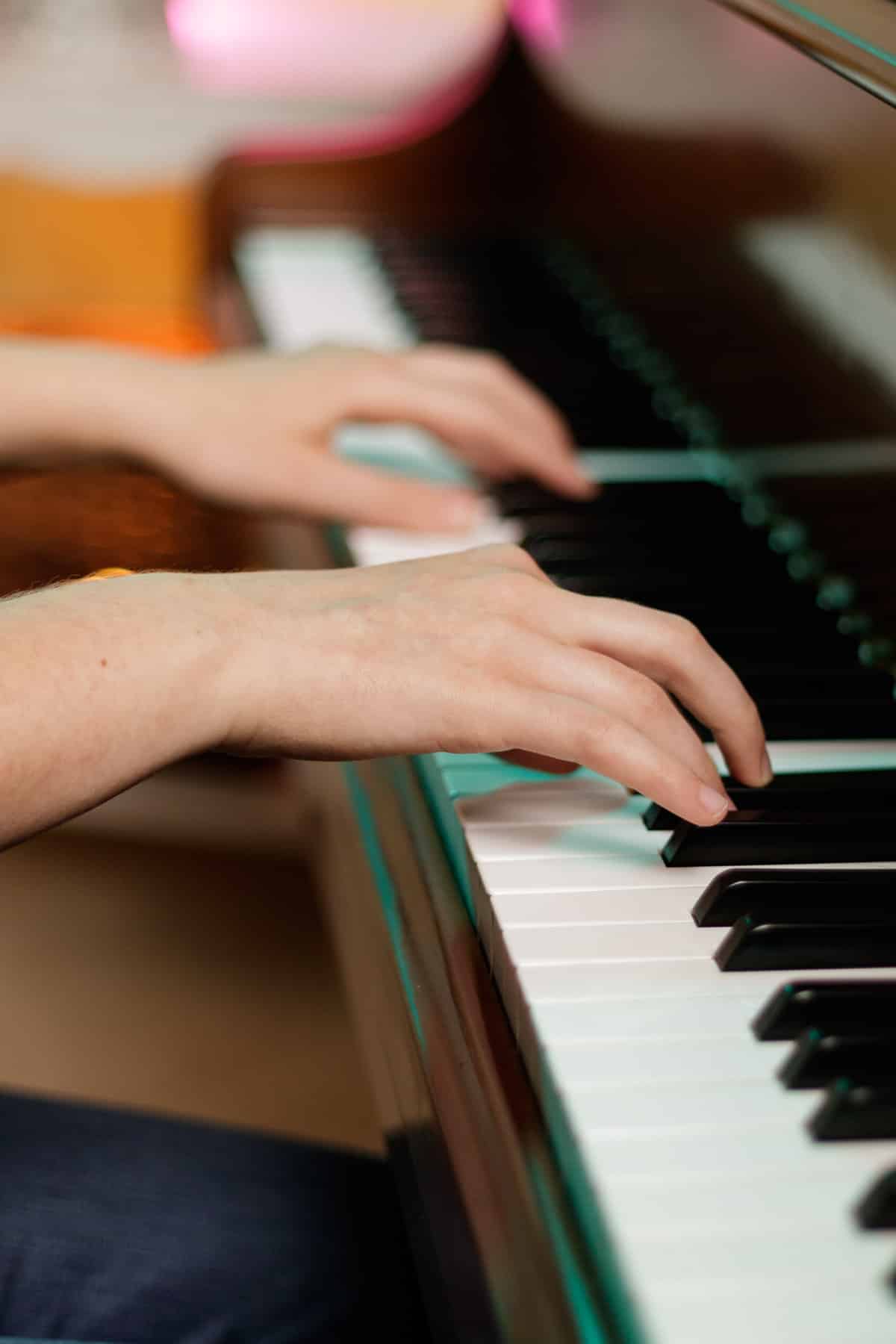 person playing scales on piano