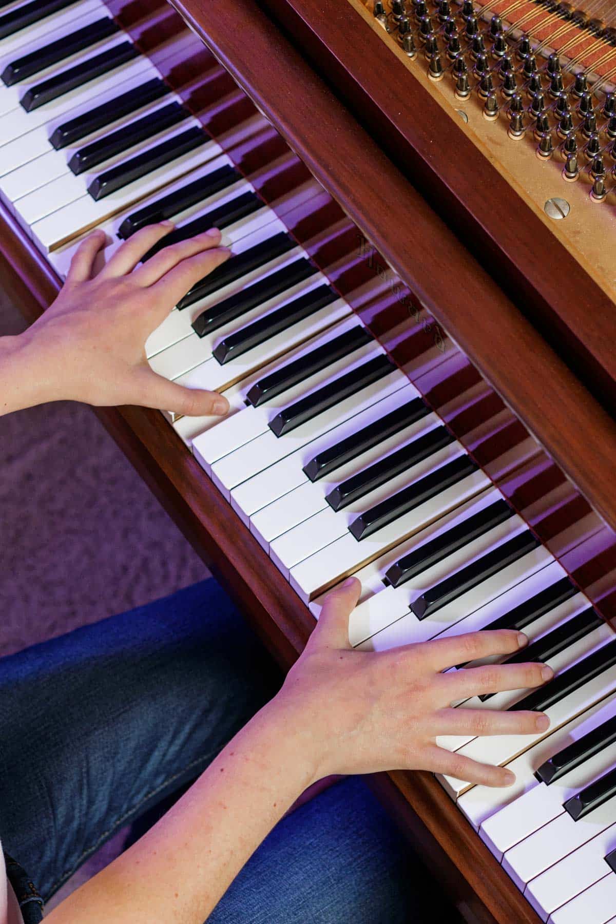 girl playing octaves on a piano