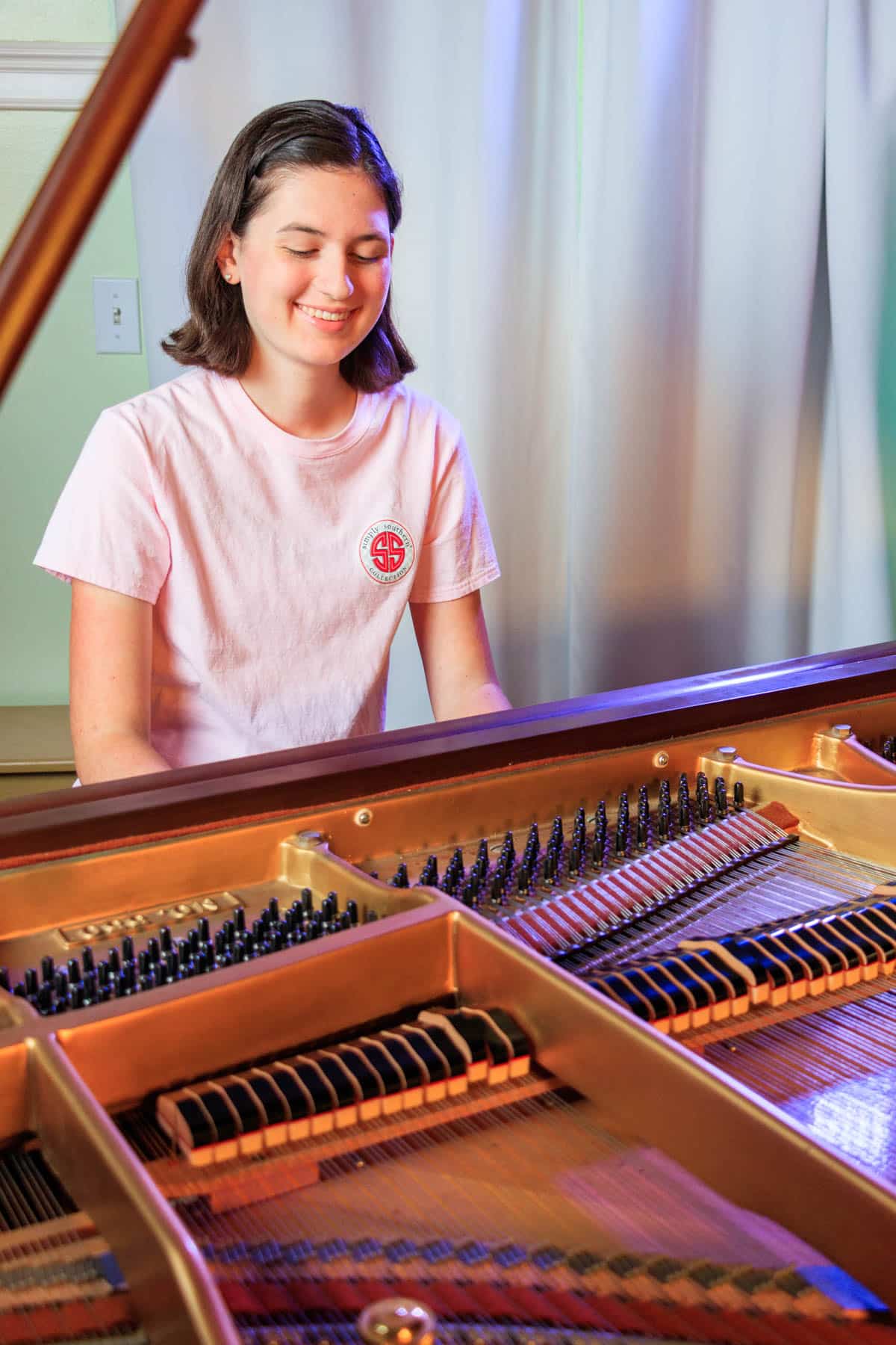 girl playing a grand piano
