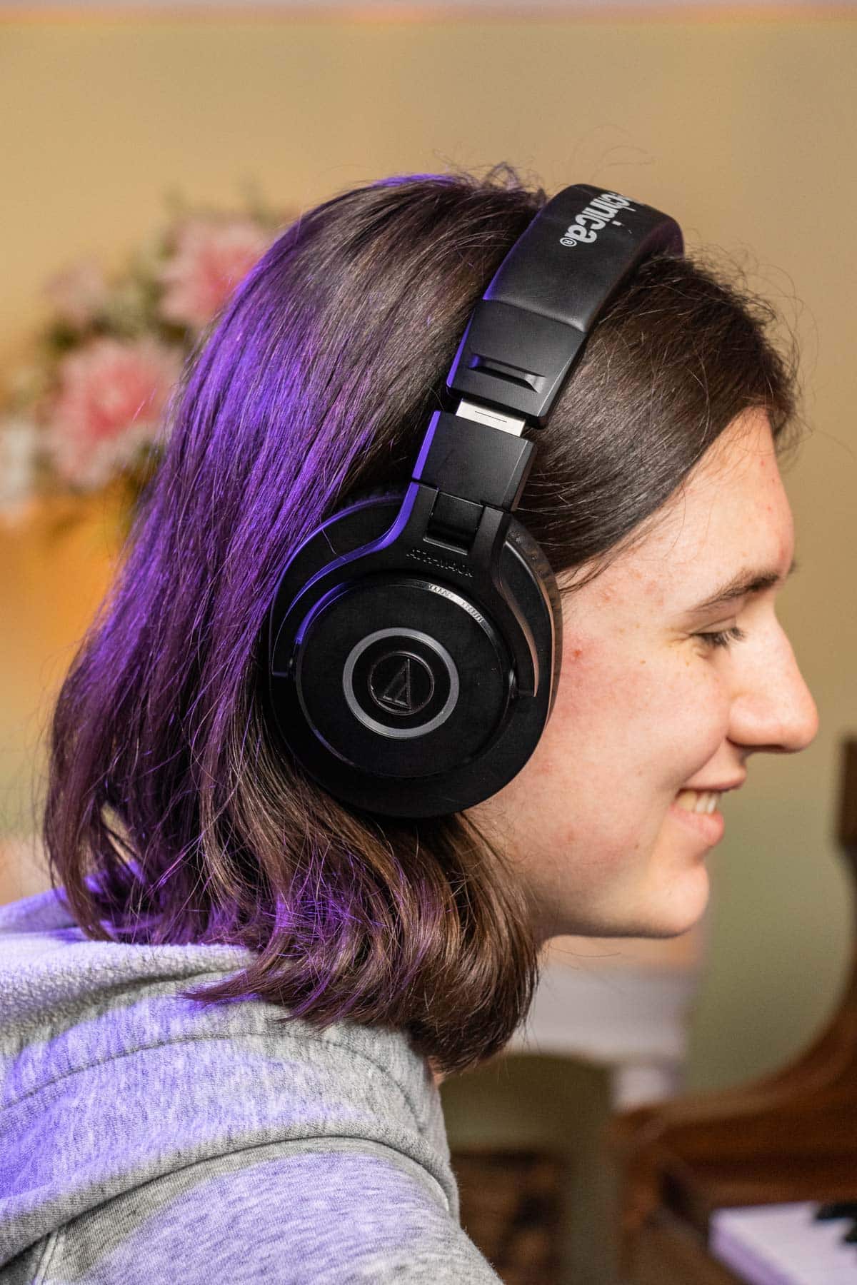 teenage girl wearing Audio Technica M40x headphones