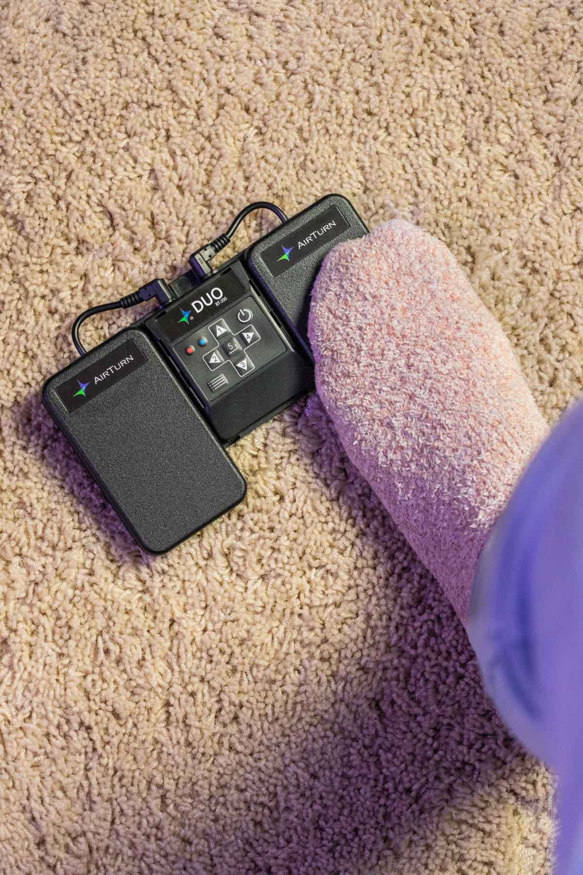 person using AirTurn Duo Bluetooth foot pedal